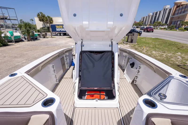 Slide: The Image of 2025 Yamaha Boats 255 FSH Sport E interior with open storage compartments and seating. - 37