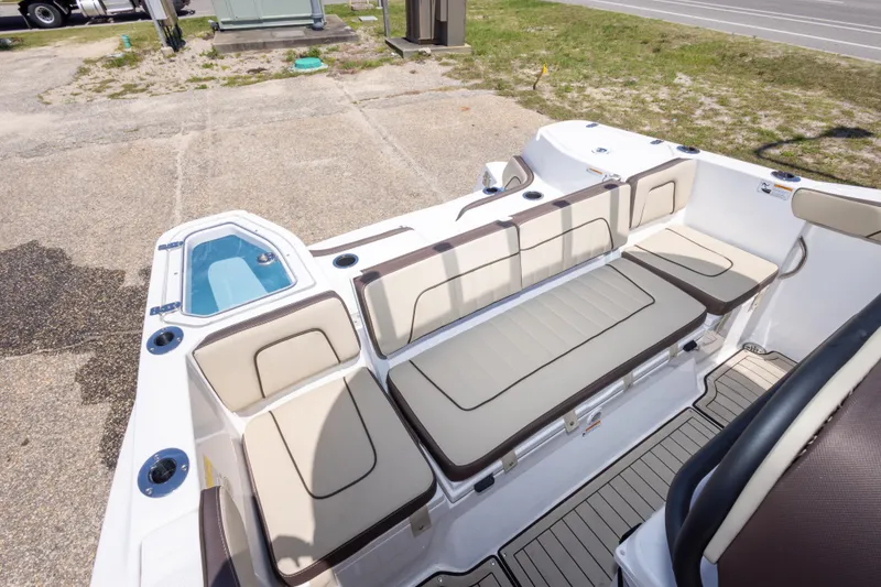 Slide: The Image of 2025 Yamaha Boats 255 FSH Sport E interior with beige seating and storage compartments. - 46