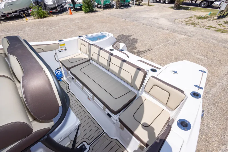Slide: The Image of 2025 Yamaha Boats 255 FSH Sport E interior with beige seating and deck view. - 47