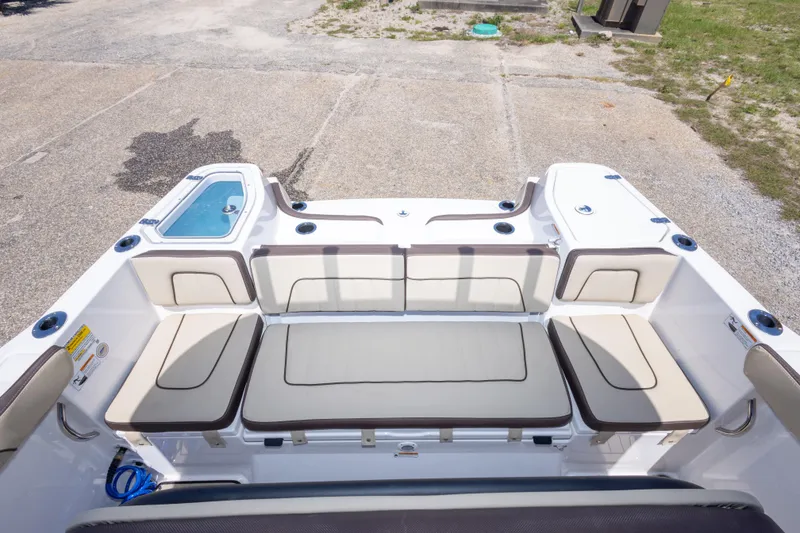 Slide: The Image of 2025 Yamaha Boats 255 FSH Sport E interior with cushioned seating and storage compartments. - 48