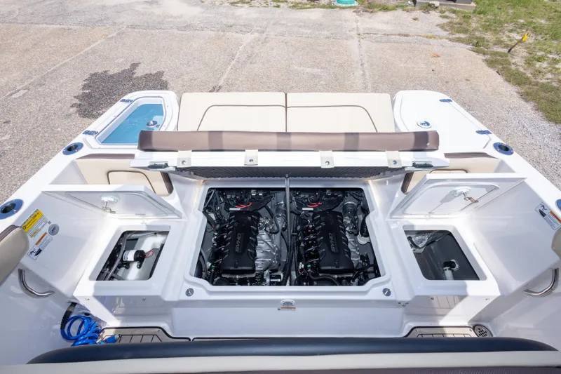 Slide: The Image of 2025 Yamaha Boats 255 FSH Sport E engine compartment, showcasing dual engines and storage areas. - 49