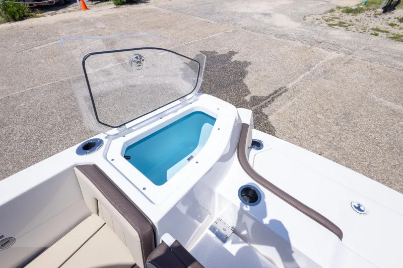 Slide: The Image of 2025 Yamaha Boats 255 FSH Sport E, open storage compartment, sleek design. - 51