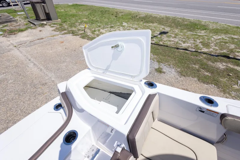 Slide: The Image of 2025 Yamaha Boats 255 FSH Sport E open storage compartment, showcasing sleek design and functionality. - 52