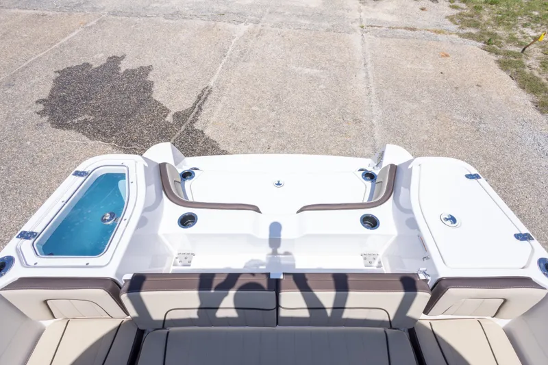 Slide: The Image of 2025 Yamaha Boats 255 FSH Sport E, rear deck view with seating and storage compartments. - 53