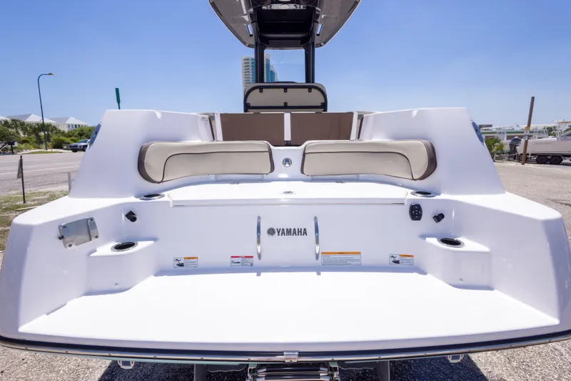 Slide: The Image of 2025 Yamaha Boats 255 FSH Sport E, rear view with seating and cup holders. - 56