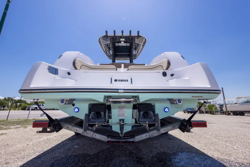 Slide: The Image of Rear view of 2025 Yamaha Boats 255 FSH Sport E on trailer under clear sky. - 57