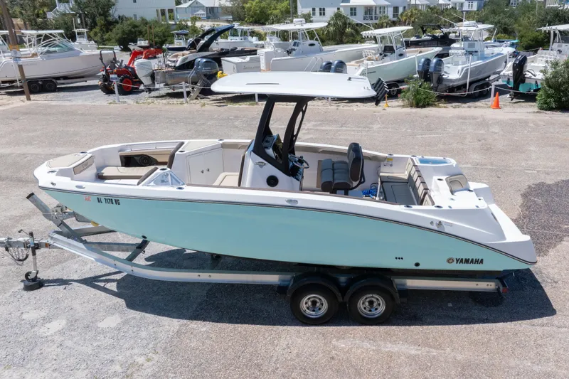 Slide: The Image of 2025 Yamaha Boats 255 FSH Sport E on trailer, parked in marina lot. - 58