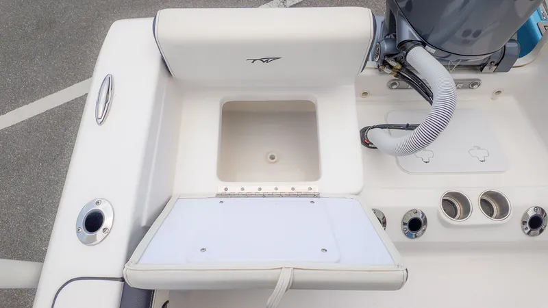 Slide: The Image of Tidewater 198 CC Adventure 2025 boat rear with storage and engine connections. - 6