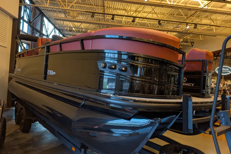 Slide: The Image of 2026 Regency 230 DL pontoon boat displayed indoors, showcasing sleek design and modern features. - 1