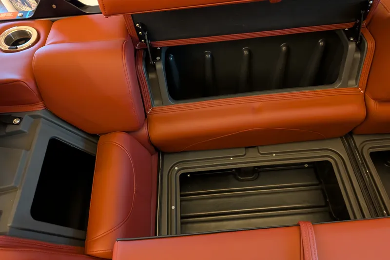 Slide: The Image of 2026 Regency 230 DL interior storage compartments with luxurious brown leather seating. - 6