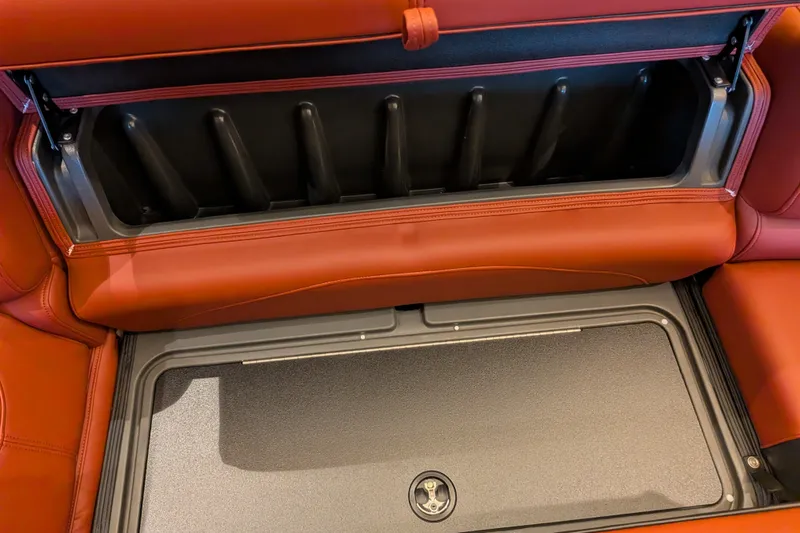 Slide: The Image of Red leather storage compartment in 2026 Regency 230 DL boat interior. - 11