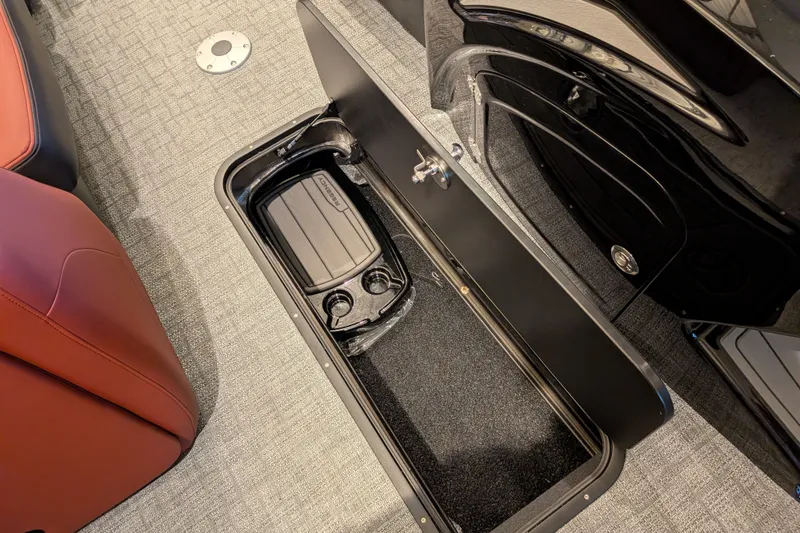 Slide: The Image of Storage compartment in 2026 Regency 230 DL boat with cup holders and carpeted interior. - 7