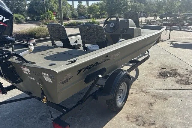 Slide: The Image of 2026 Tracker Grizzly 1754 SC boat on trailer, parked outdoors in sunny setting. - 9