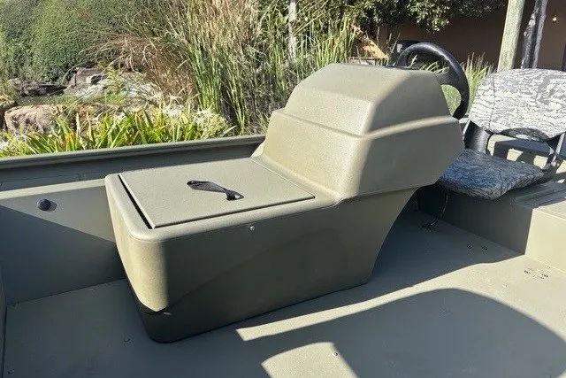 Slide: The Image of 2026 Tracker Grizzly 1754 SC boat interior with seating and storage compartment. - 4