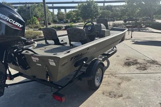 Slide: The Image of 2026 Tracker Grizzly 1754 SC boat on trailer, parked outdoors in sunny setting. - 7