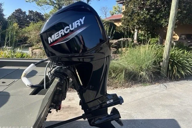 Slide: The Image of 2026 Tracker Grizzly 1754 SC boat with Mercury outboard motor in outdoor setting. - 10