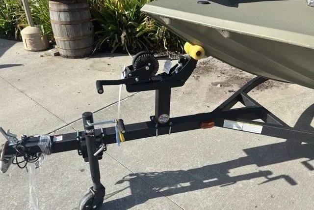 Slide: The Image of 2026 Tracker Grizzly 1754 SC boat trailer with winch on concrete surface. - 8