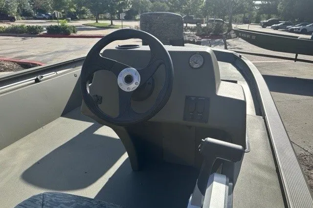 Slide: The Image of 2026 Tracker Grizzly 1754 SC boat interior with steering wheel and control panel. - 5