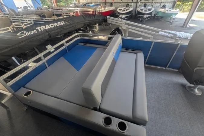 Slide: The Image of 2026 Sun Tracker Party Barge 22 RF XP3 interior with gray and blue seating, cup holders. - 2