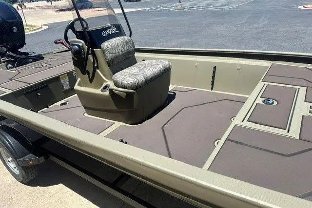 Slide: The Image of 2026 Tracker Grizzly 1860 CC boat with central console and cushioned seat. - 13