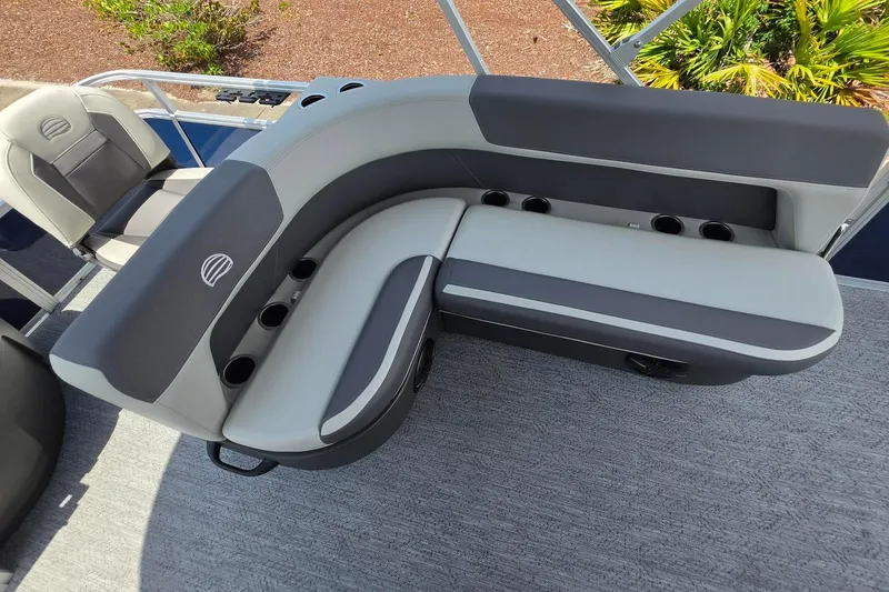 Slide: The Image of 2026 Sun Tracker Bass Buggy 18 DLX pontoon boat seating with cup holders and gray upholstery. - 20