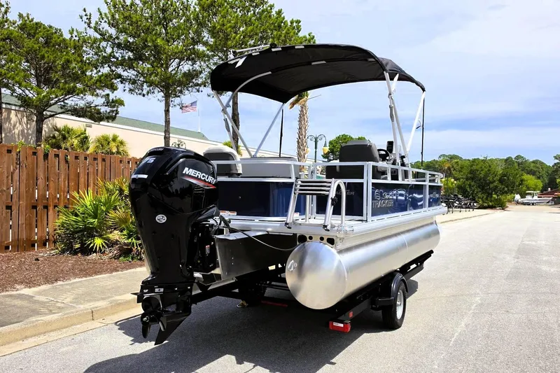 Slide: The Image of 2026 Sun Tracker Bass Buggy 18 DLX pontoon boat with Mercury engine on trailer. - 4
