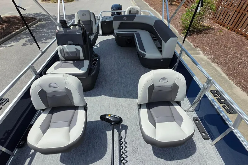 Slide: The Image of 2026 Sun Tracker Bass Buggy 18 DLX pontoon boat interior with seating and controls. - 18