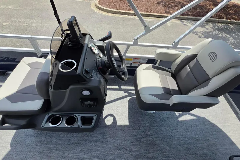 Slide: The Image of 2026 Sun Tracker Bass Buggy 18 DLX interior with steering console and seating. - 16