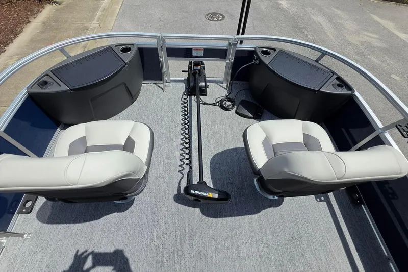Slide: The Image of 2026 Sun Tracker Bass Buggy 18 DLX pontoon boat interior with two seats and a trolling motor. - 23