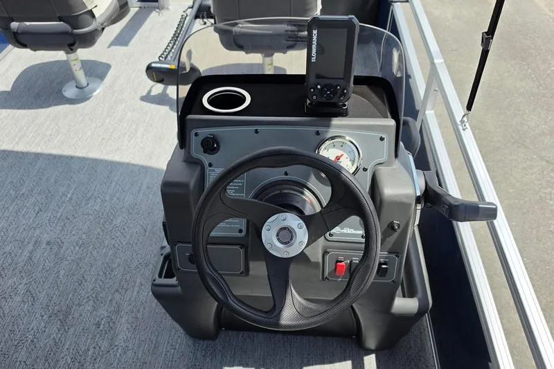 Slide: The Image of 2026 Sun Tracker Bass Buggy 18 DLX steering console with gauges and navigation system. - 17