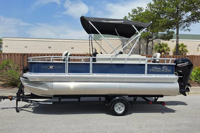 Slide: The Image of 2026 Sun Tracker Bass Buggy 18 DLX pontoon boat with canopy and Mercury outboard motor. - 11