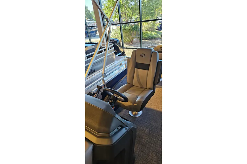 Slide: The Image of 2026 Sun Tracker Sportfish 24 XP3 boat interior with captain's chair and steering wheel. - 13