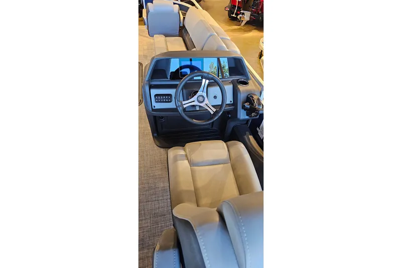 Slide: The Image of Interior view of 2026 Sun Tracker Sportfish 24 XP3 boat, featuring steering console and seating. - 15