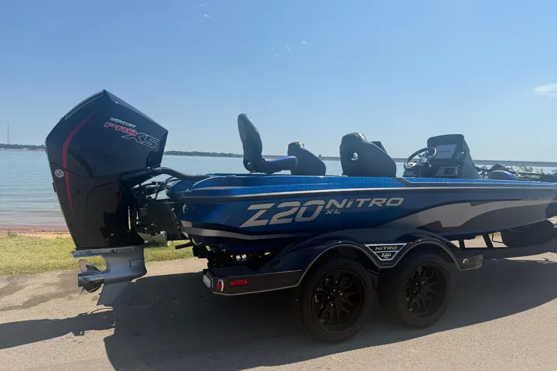 Slide: The Image of 2026 Nitro Z20 XL Pro boat with Mercury Pro XS engine by a lake. - 1