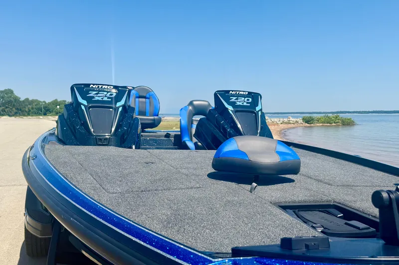 Slide: The Image of 2026 Nitro Z20 XL Pro boat on a sunny lakeside, featuring dual engines and blue seating. - 7