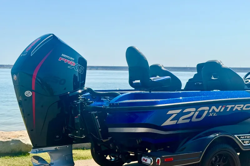 Slide: The Image of 2026 Nitro Z20 XL Pro boat with Mercury Pro XS engine by the water. - 3