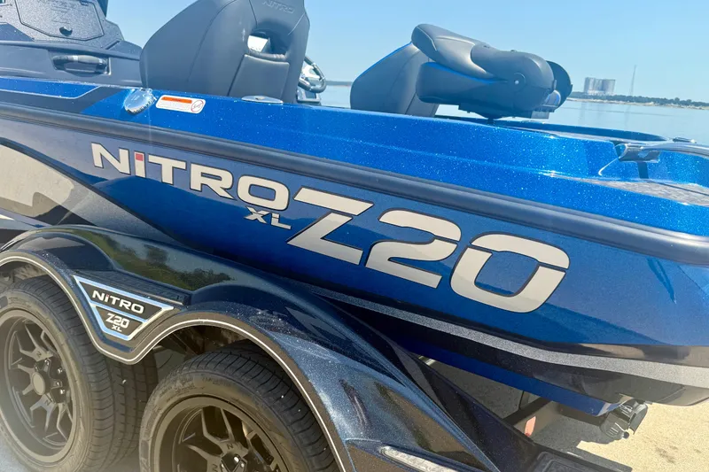 Slide: The Image of 2026 Nitro Z20 XL Pro boat in blue, parked on a trailer by the water. - 17