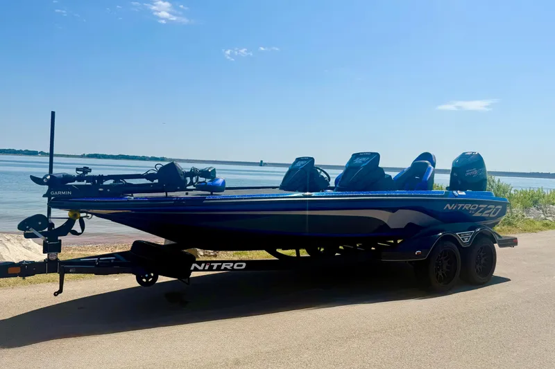Slide: The Image of 2026 Nitro Z20 XL Pro boat on trailer by a serene lake under clear blue sky. - 9