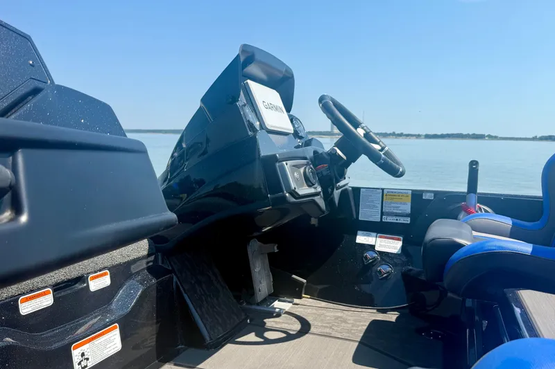 Slide: The Image of 2026 Nitro Z20 XL Pro boat cockpit with steering wheel and controls, overlooking calm water. - 18