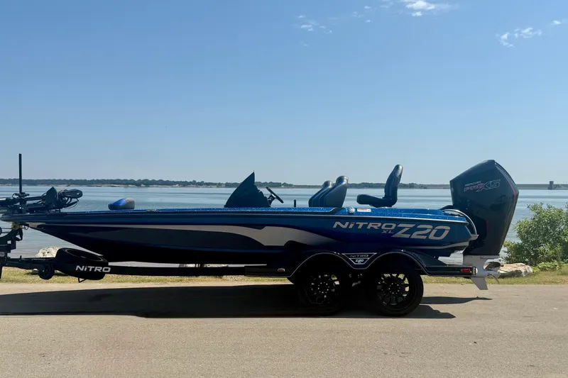 Slide: The Image of 2026 Nitro Z20 XL Pro boat parked by a serene lakeside. - 11
