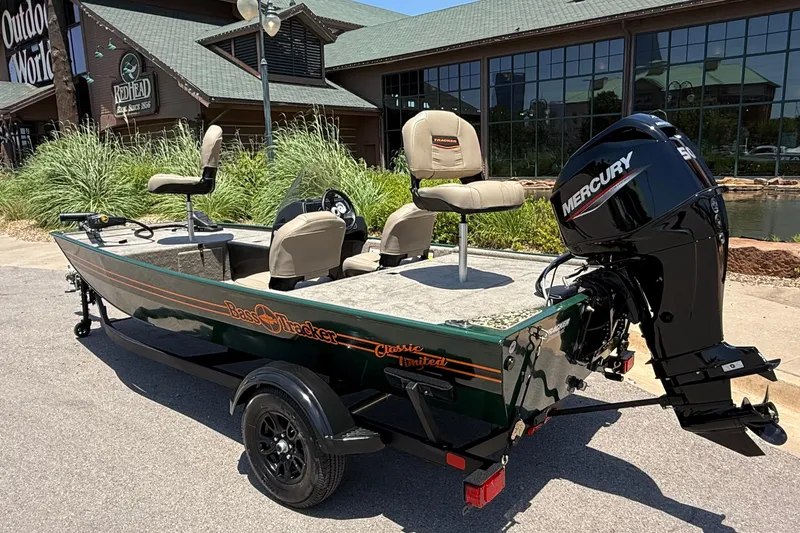 Slide: The Image of 2026 Tracker Bass Tracker Classic Limited boat with Mercury engine outside a store. - 3