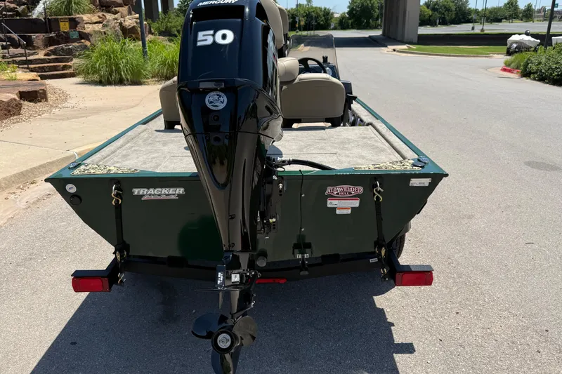 Slide: The Image of 2026 Tracker Bass Tracker Classic Limited boat with Mercury 50 engine, parked outdoors. - 5