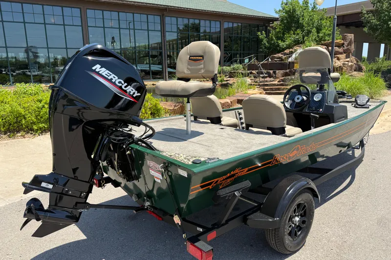 Slide: The Image of 2026 Tracker Bass Tracker Classic Limited boat with Mercury engine, parked outdoors. - 6