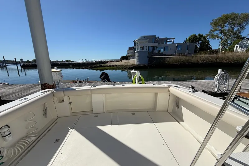 Slide: The Image of 1987 Phoenix 34 SFX Convertible boat docked by waterfront property. - 13