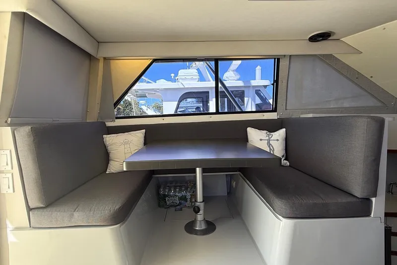 Slide: The Image of Interior of 1987 Phoenix 34 SFX Convertible with gray seating and table, featuring nautical decor. - 19