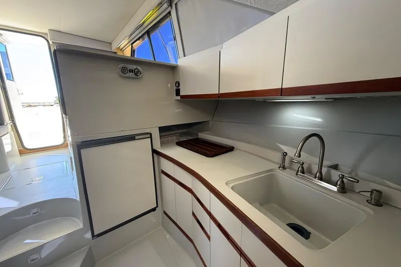 Slide: The Image of 1987 Phoenix 34 SFX Convertible yacht kitchen with modern sink and cabinetry. - 21