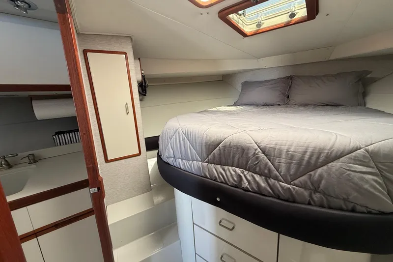 Slide: The Image of Cozy cabin interior of 1987 Phoenix 34 SFX Convertible with bed and storage. - 23