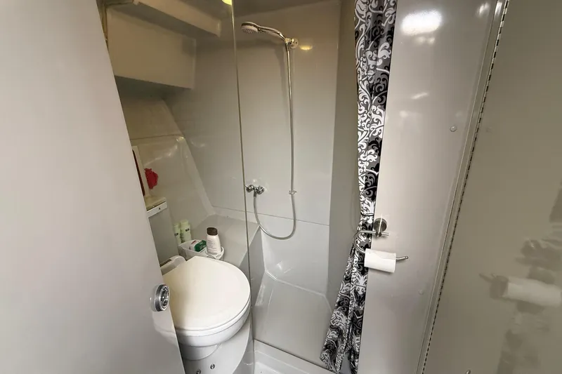 Slide: The Image of Compact bathroom in 1987 Phoenix 34 SFX Convertible with shower and patterned curtain. - 25