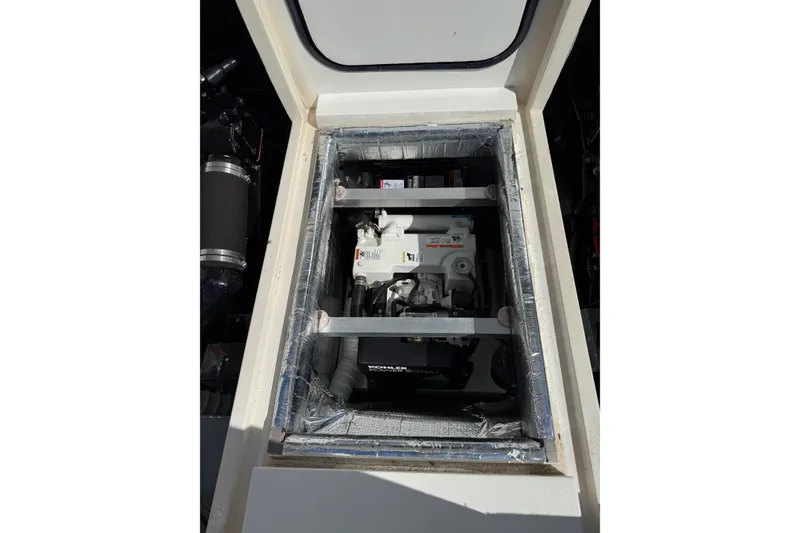 Slide: The Image of Engine compartment of a 1987 Phoenix 34 SFX Convertible boat, showcasing mechanical components. - 30