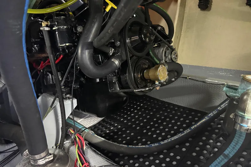 Slide: The Image of Engine compartment of a 1987 Phoenix 34 SFX Convertible boat, showcasing hoses and components. - 33